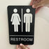 Unisex Braille Restroom Sign - 9 x 6 Inch with Graphical Symbols and Double Sided 3M Tape (Black)