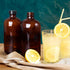 12 Pack 16 oz Amber Boston Round Glass Bottles with Black Caps for Kombucha Fermentation and Lab Chemicals (2 Funnels